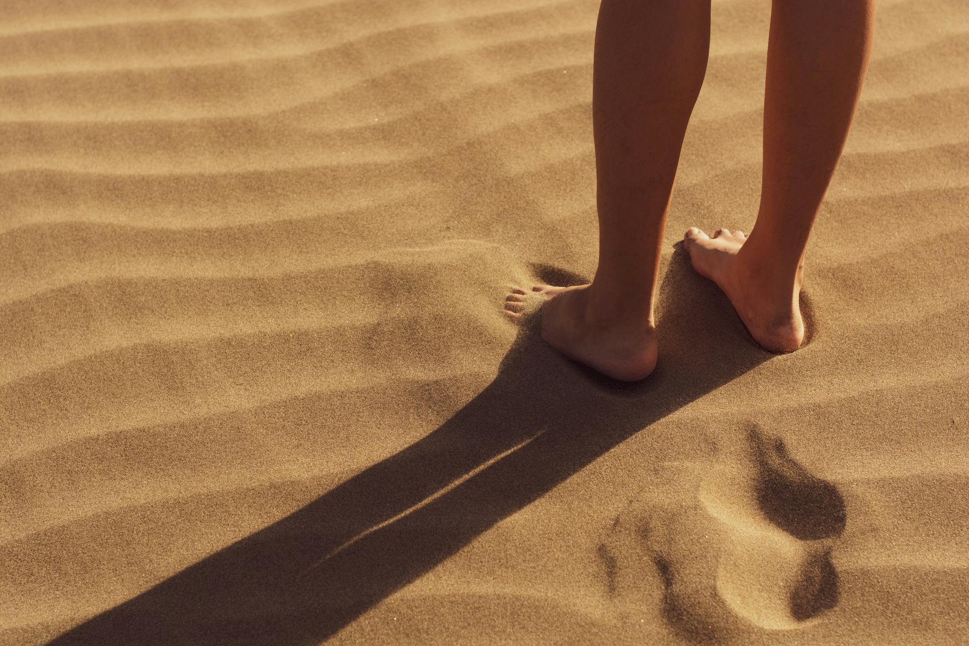 feet on the sand in the desert