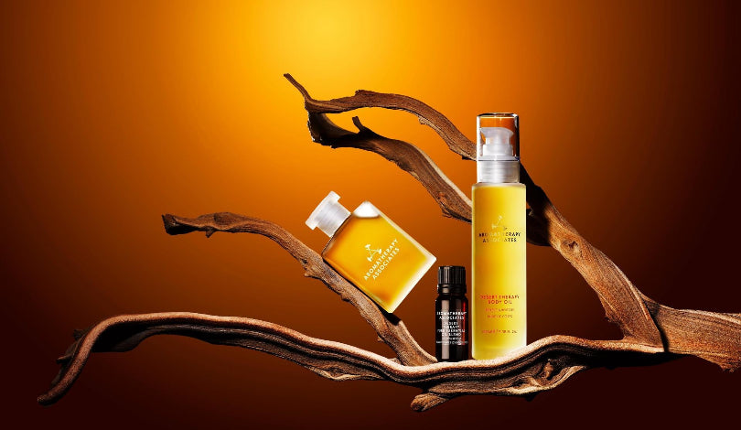 Aromatherapy Associates Desert Therapy on a wooden branch against an orange background