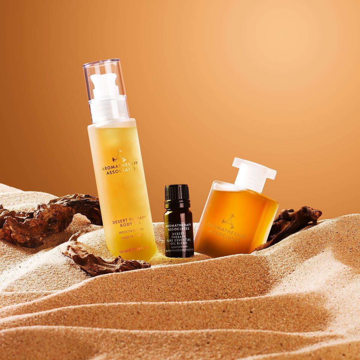 Aromatherapy Associates Desert Therapy collection on sand with a warm color palette
