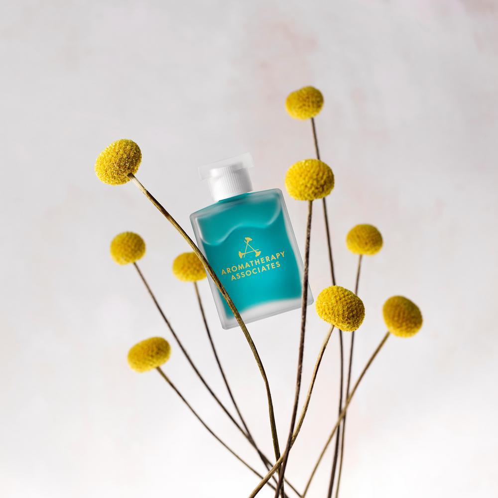 Aromatherapy Associates product with yellow flowers on a light background