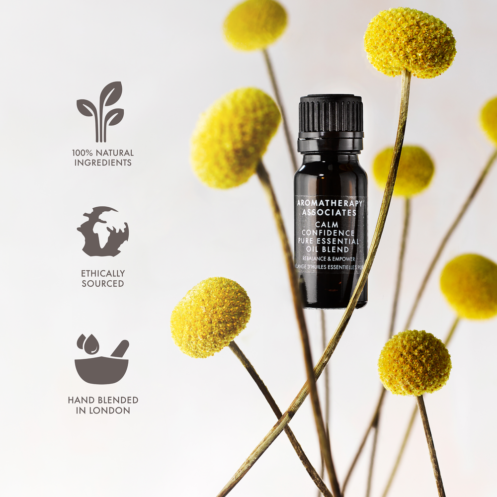 Aromatherapy Associates calm confidence essential oil bottle with yellow flowers and certification icons on a light background