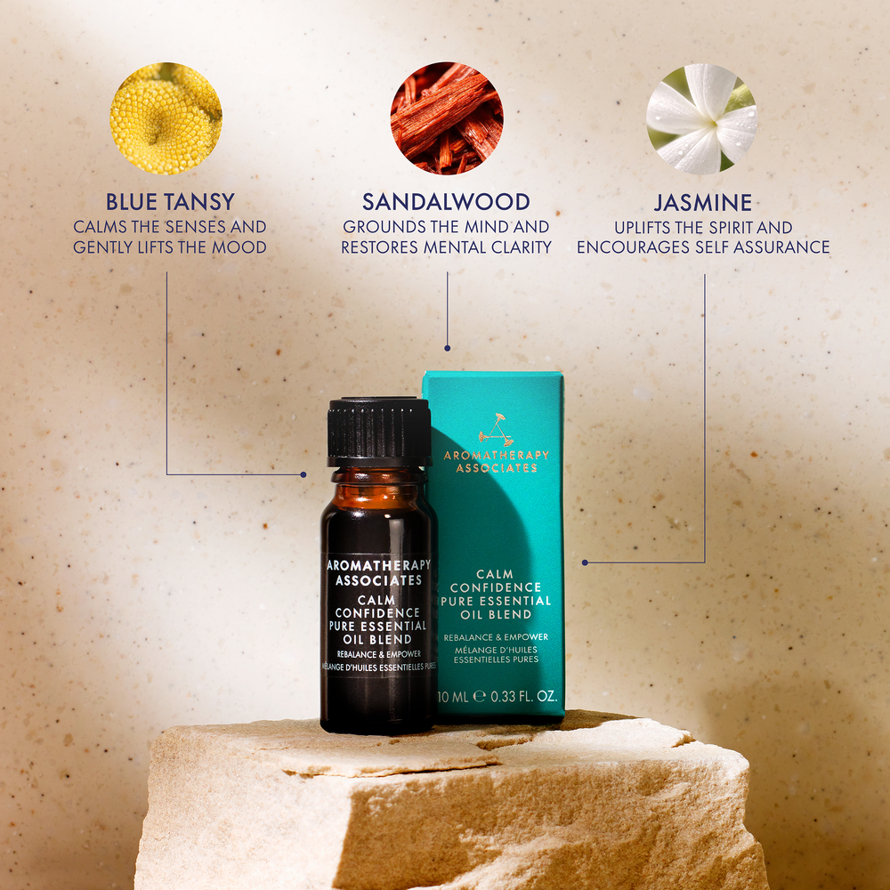 Aromatherapy Associates Calm Confidence essential oil bottle and packaging on a stone surface with essential oils' benefits displayed.