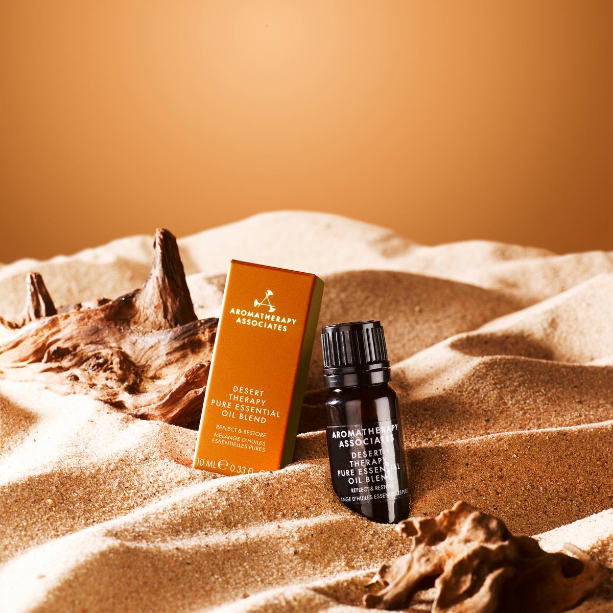 Aromatherapy Associates desert therapy product on sand with a warm color palette