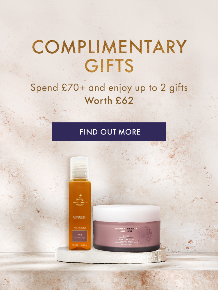 Cosmetic products on a shelf with promotional text for complimentary gifts.