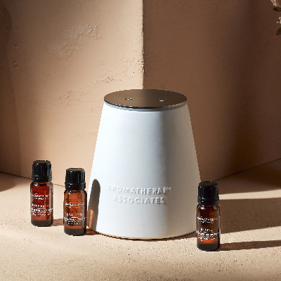 Aromatherapy Associates Atomiser with essential oil bottles on a neutral background