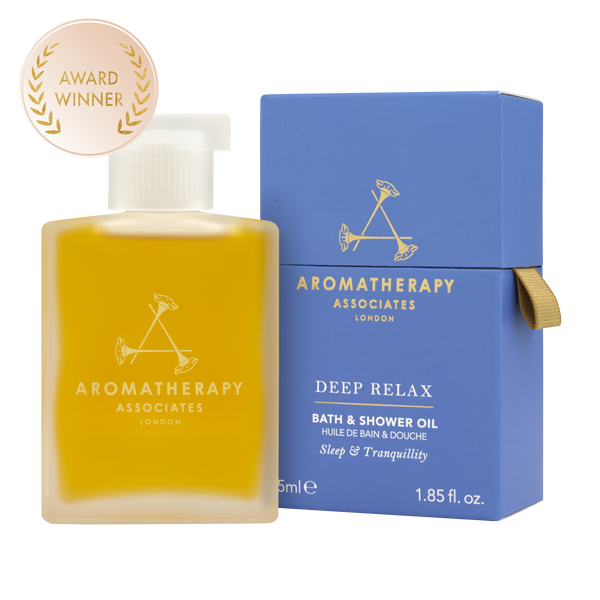 Packaging and bottle of Deep Relax Bath & Shower Oil by Aromatherapy Associates, with a award badge in the top left corner.