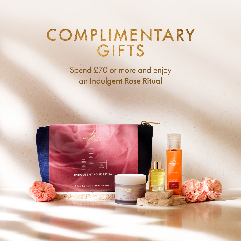 Cosmetic bag with skincare products and flowers on a soft background, promoting a complimentary gift offer.