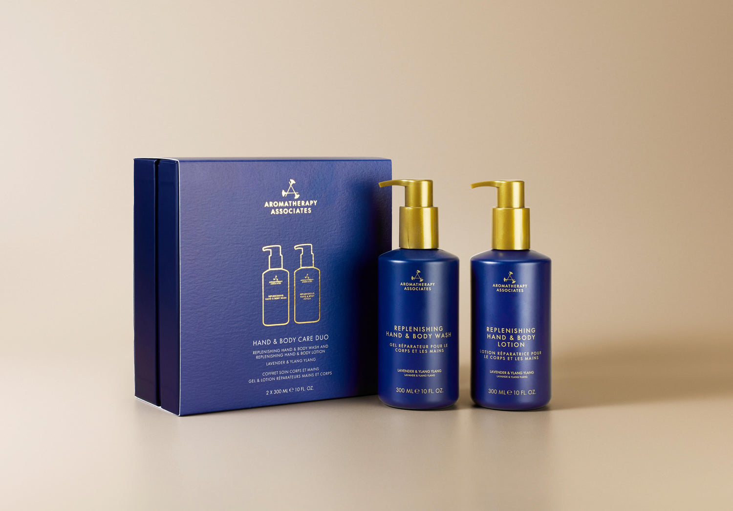 Aromatherapy Associates hand and body care set with blue bottles and packaging on a beige background