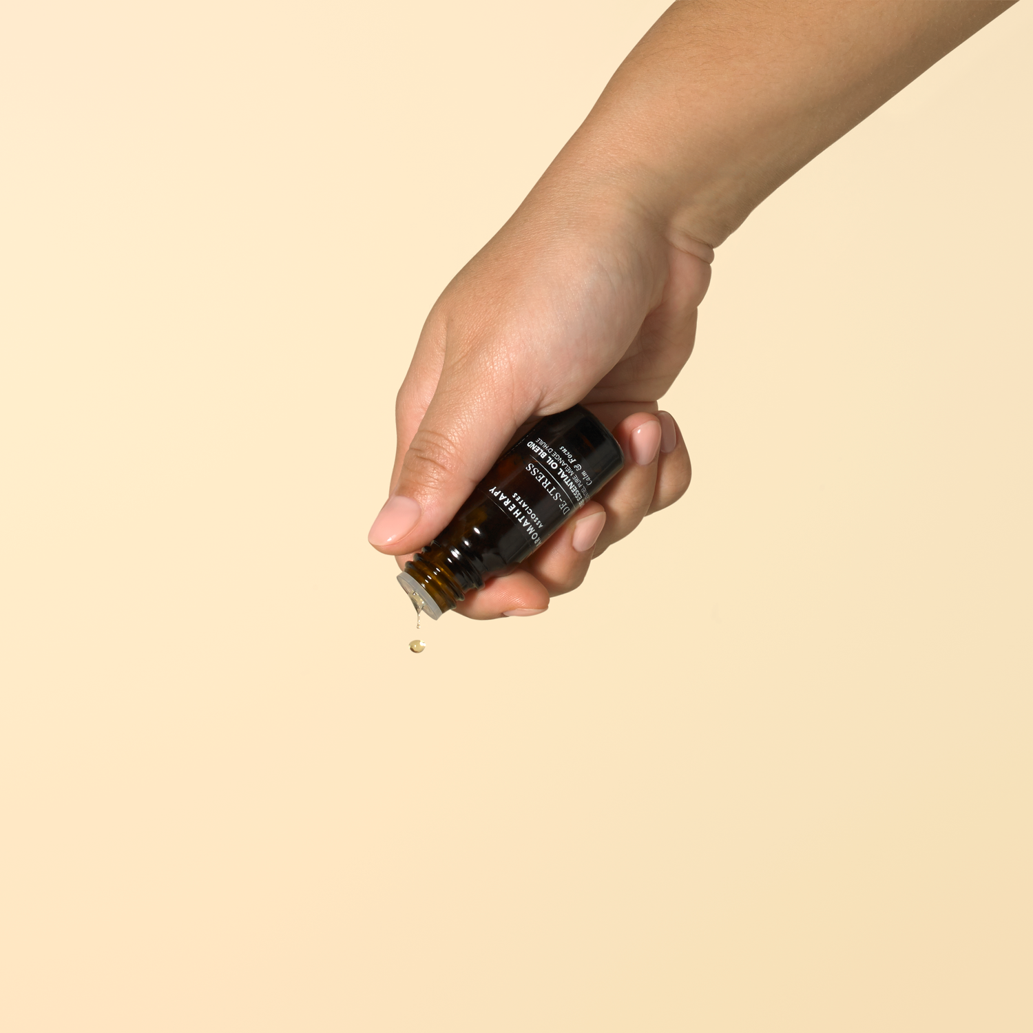 Person holding a De-Stress Pure Essential Oil Blend bottle