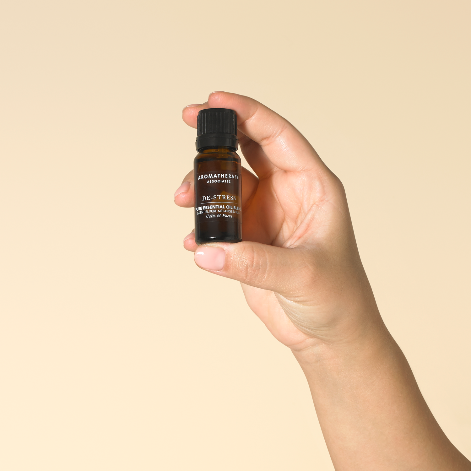 Close-up of a hand holding the De-Stress Essential Oil Blend